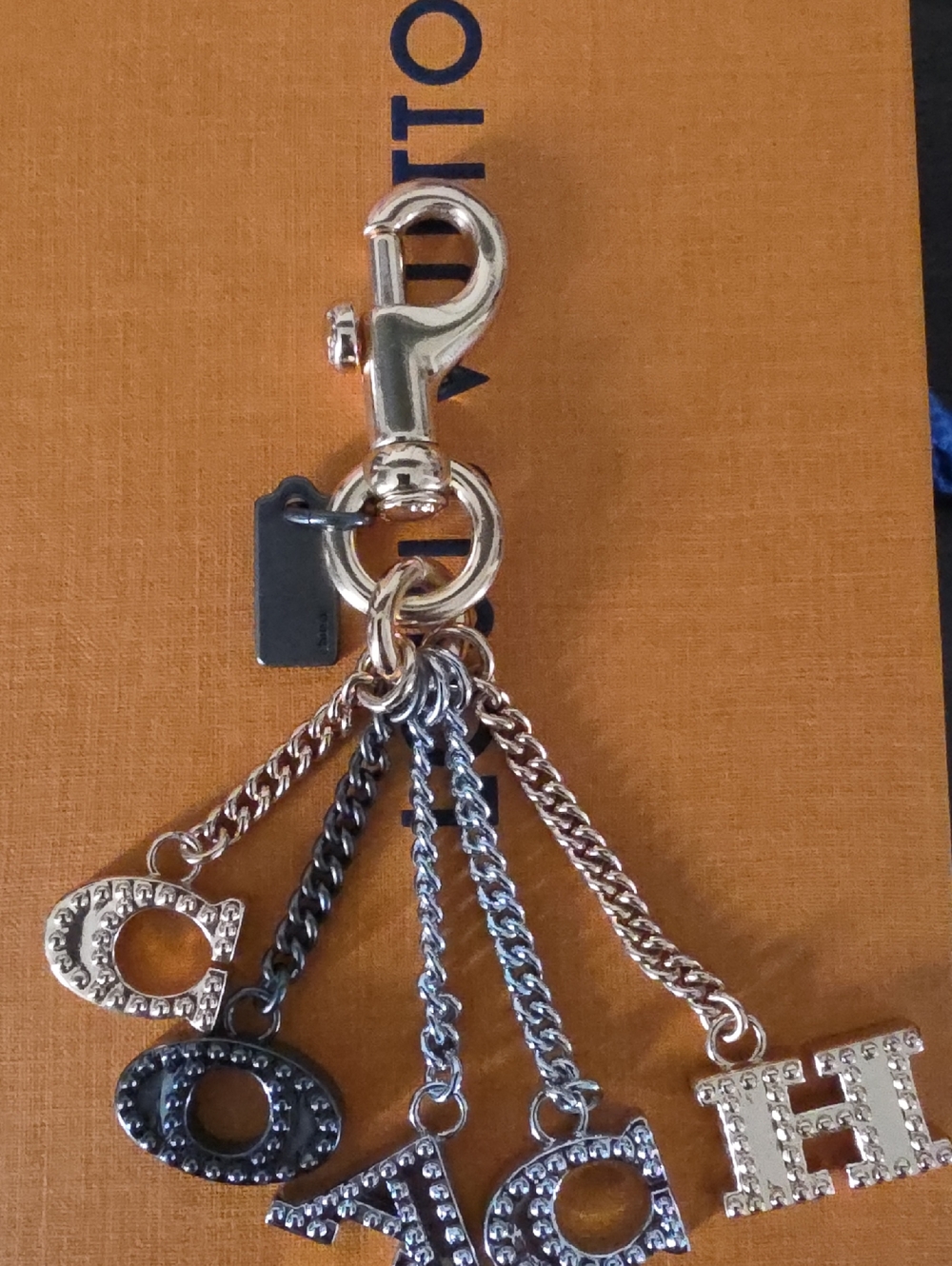 Coach Perforated "COACH" Letters Metal Bag Charm